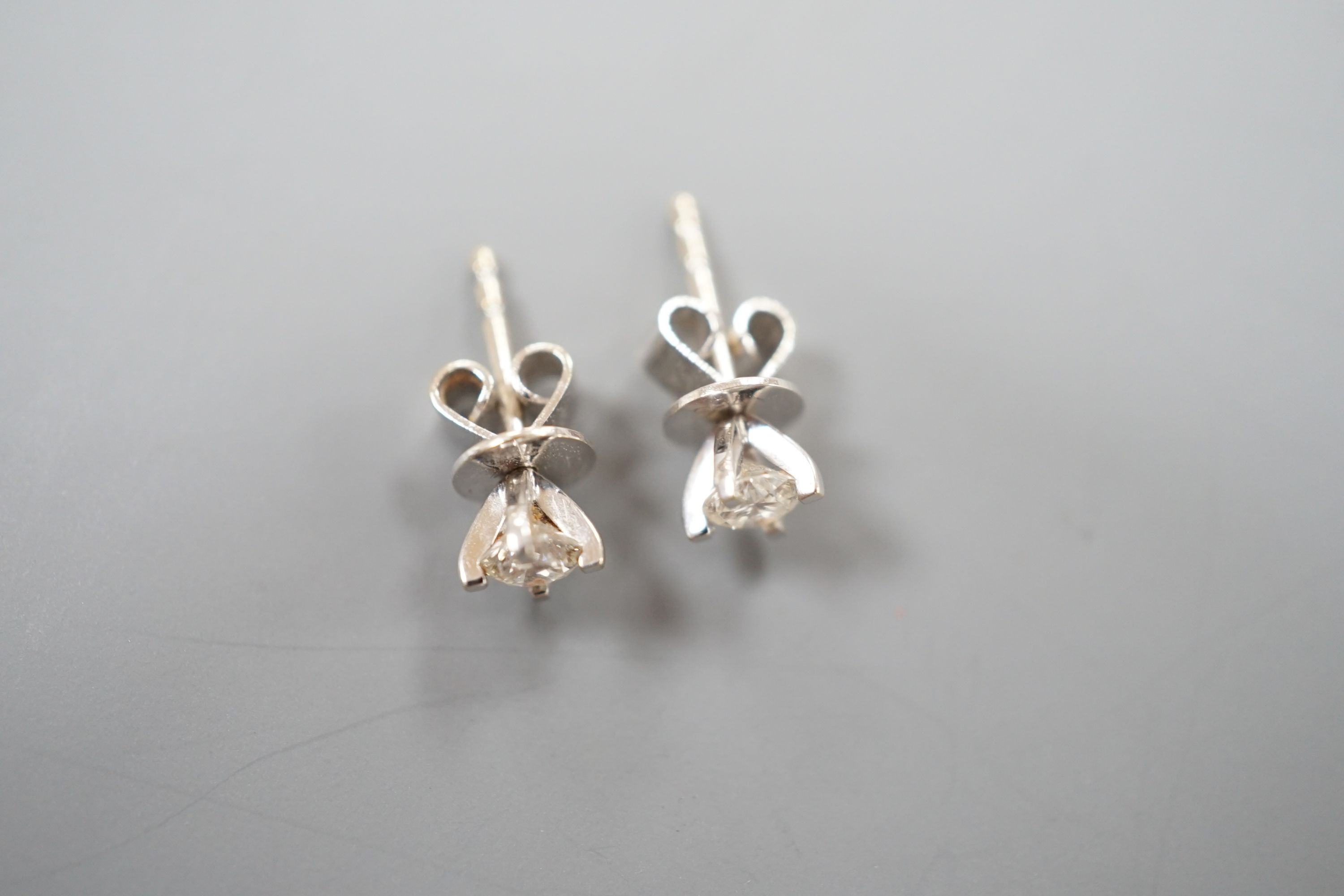 A pair of 750 white metal and solitaire diamond set ear studs, the stones measuring 3.5mm in diameter, gross weight 1.1 grams.